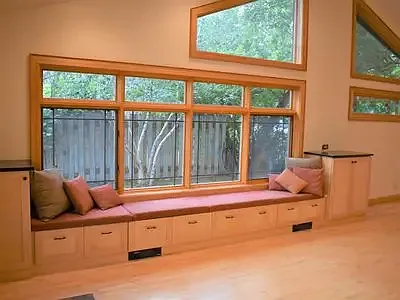 Bay window seating in dining room with drawers for storage.