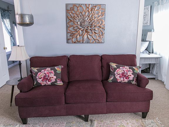 Living room area with TV and ceiling fan