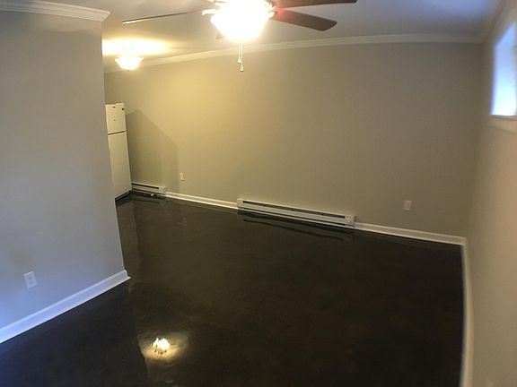 Livingroom - Unit has cental heating and AC. Baseboard heat is back up system.