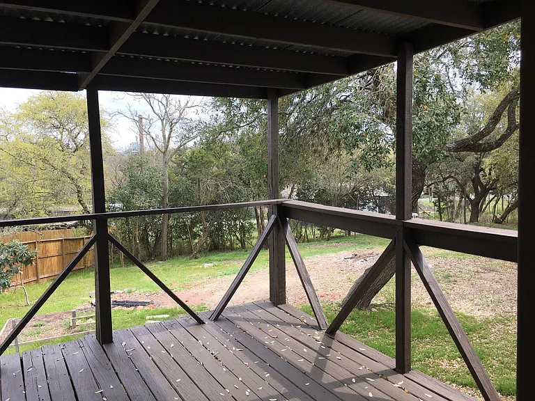 Large covered back porch overlooks back yard
