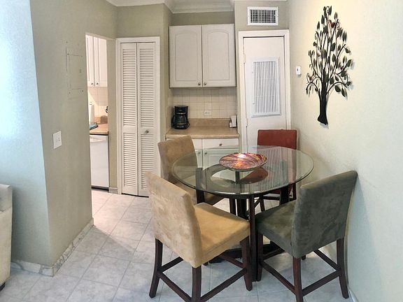 Dining table comfortably seats 4 guests right outside the fully stocked kitchen.