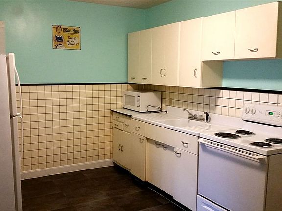 Kitchen with range and refrigerator. Plenty of storage in ca
