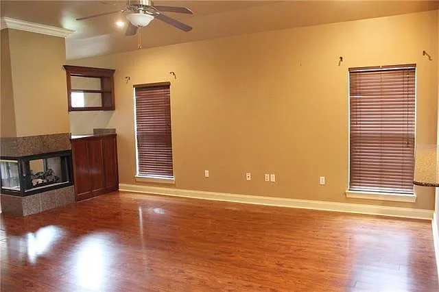 Living room with dry bar and glass fireplace
