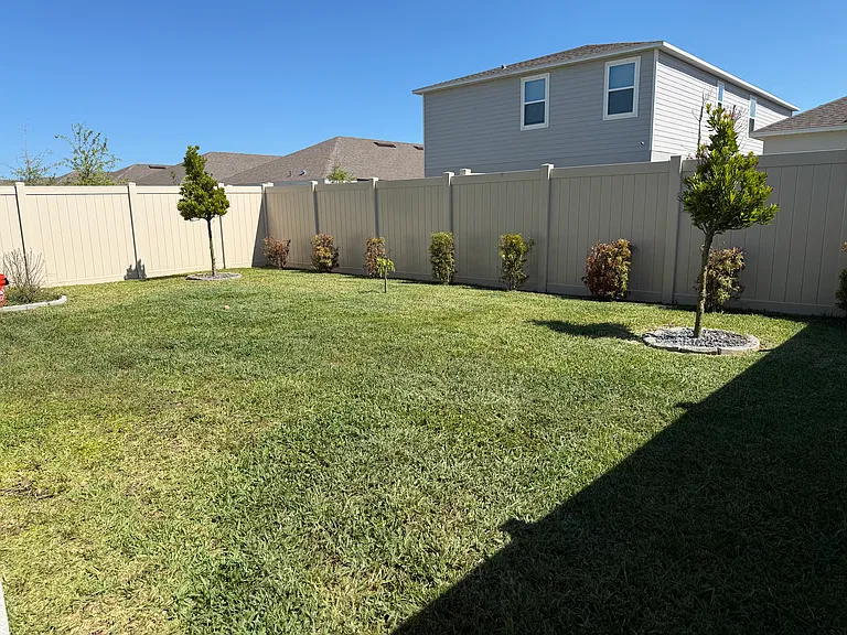 Fenced in backyard w/ two gates
