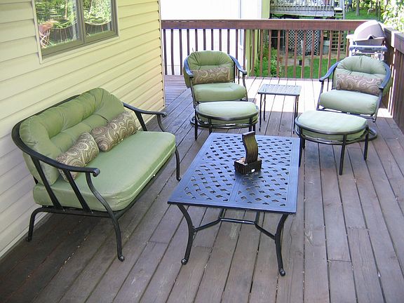 Back deck, table and 4 chairs behind spot of picture