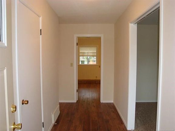 From front entrance looking towards family room straight ahead & living room on right. New flooring & paint.