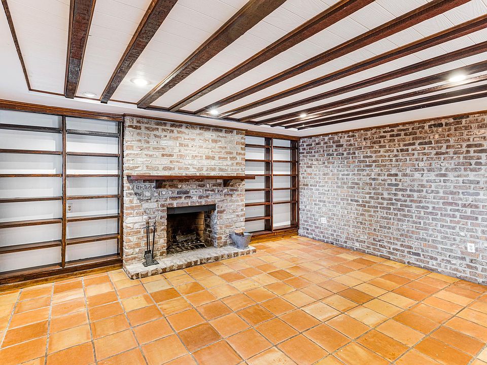 Living room with built-in bookshelves and decorative fireplace.