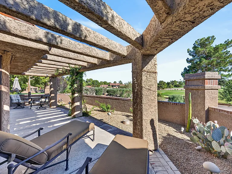 Two high end chaise chairs in the back patio with desert landscape and night landscape lighting