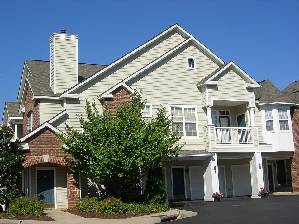 Front View of building with living space above the garage with balcony off living room.