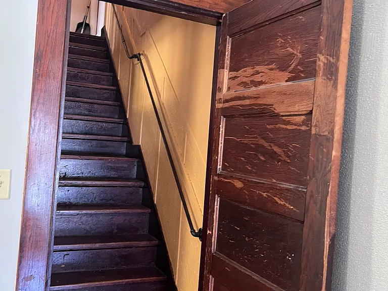 view from the living room area, looking at the staircase to the upstairs.