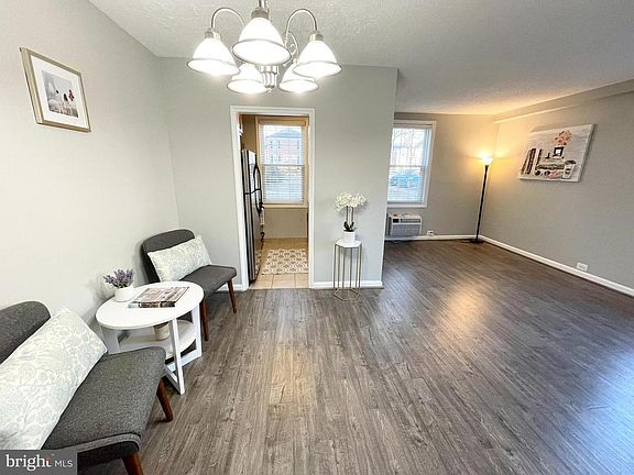 Living room and dining area are spacious and fits a sectional couch, dining table, and desk