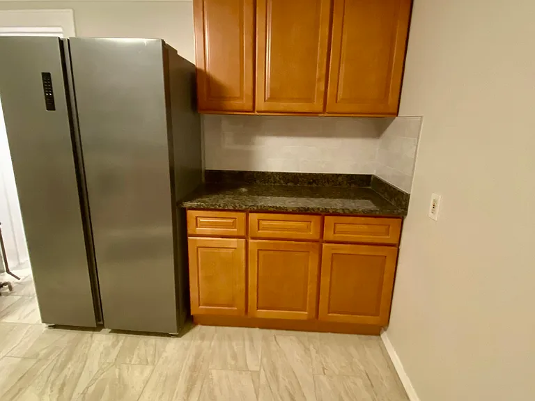 kitchen fridge, granite counter top/back splash, plenty of storage