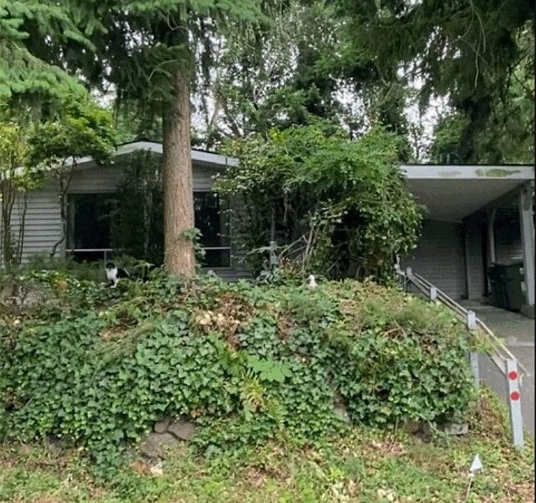 Built in 1954 this Rambler is nestled into its' Private Shy Quarter Acre Lot.