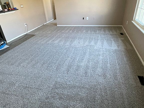 Living room from stair entrance 
during new carpet install November 2022