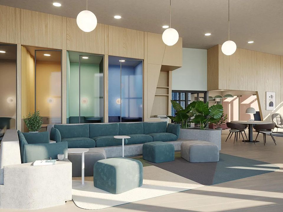 Coworking space with work pods and comfortable seating areas at Modera Riverside in Miami, FL.