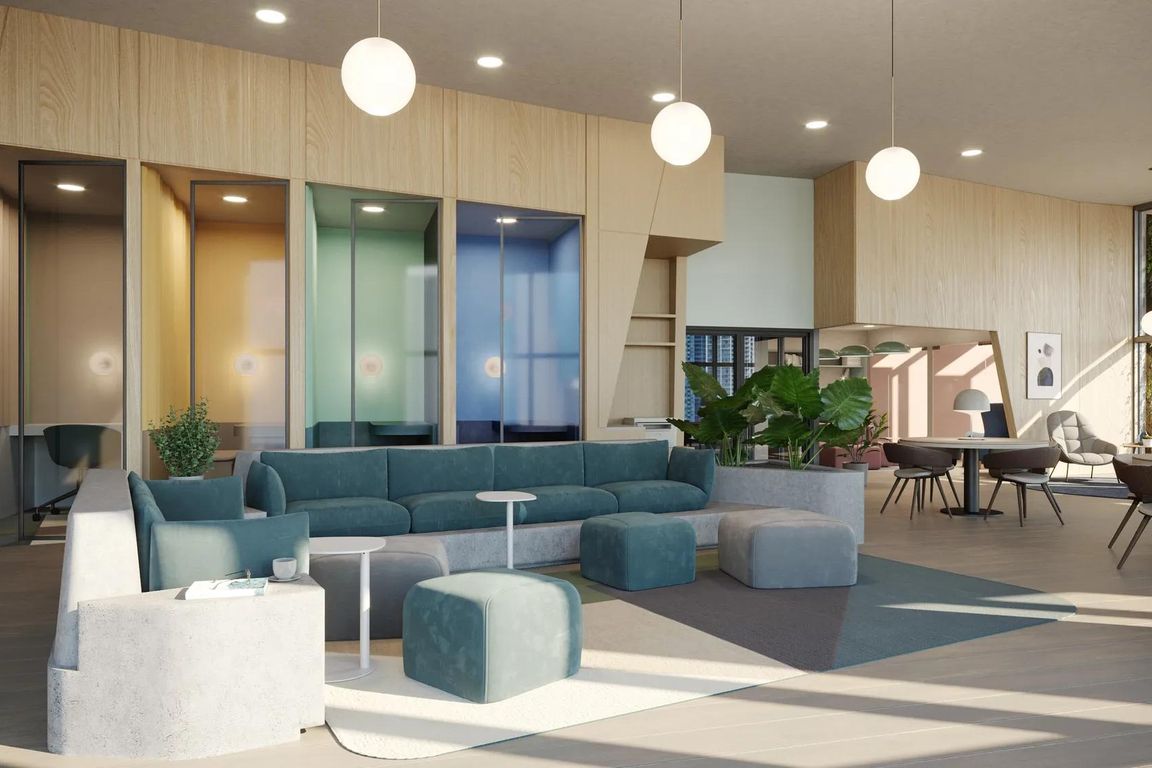 Coworking space with work pods and comfortable seating areas at Modera Riverside in Miami, FL.