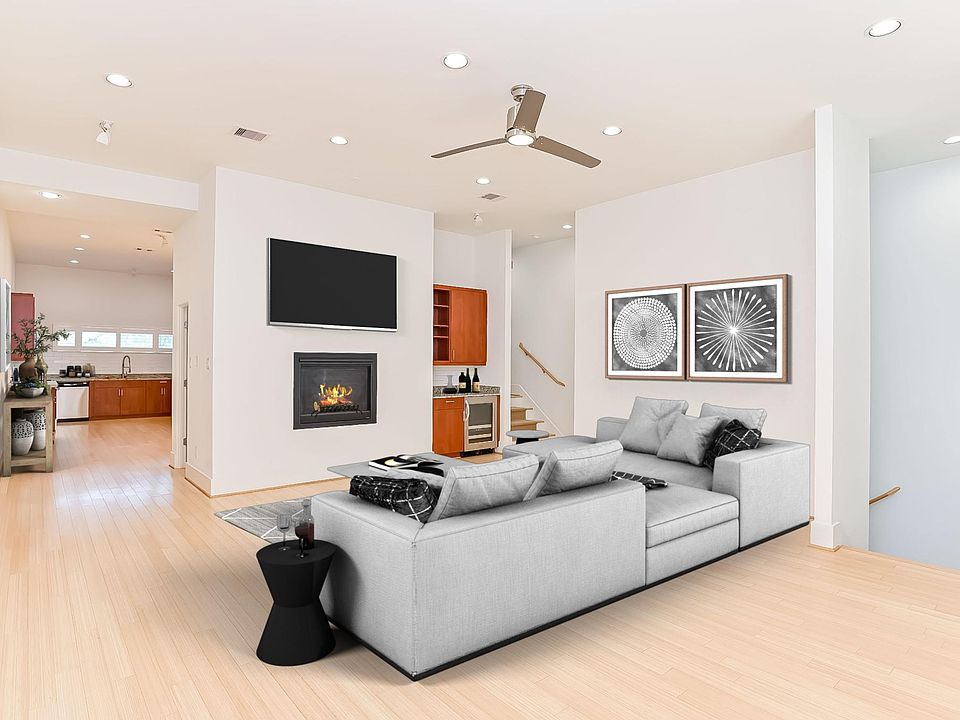 Huge 20x20 living room with gas fireplace, wine fridge, ceiling fan, LED lighting, and 12 ft ceilings.