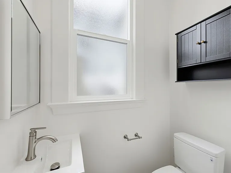 1/2 bath, great for guests, with storage cabinet and vanity