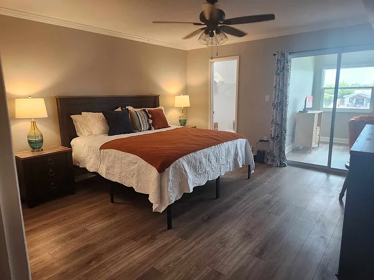 Primary bedroom with waterfront views and all new furniture.