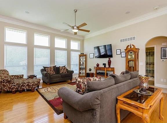 Great room area, wall of windows, triple crown molding, 11 foot ceilings