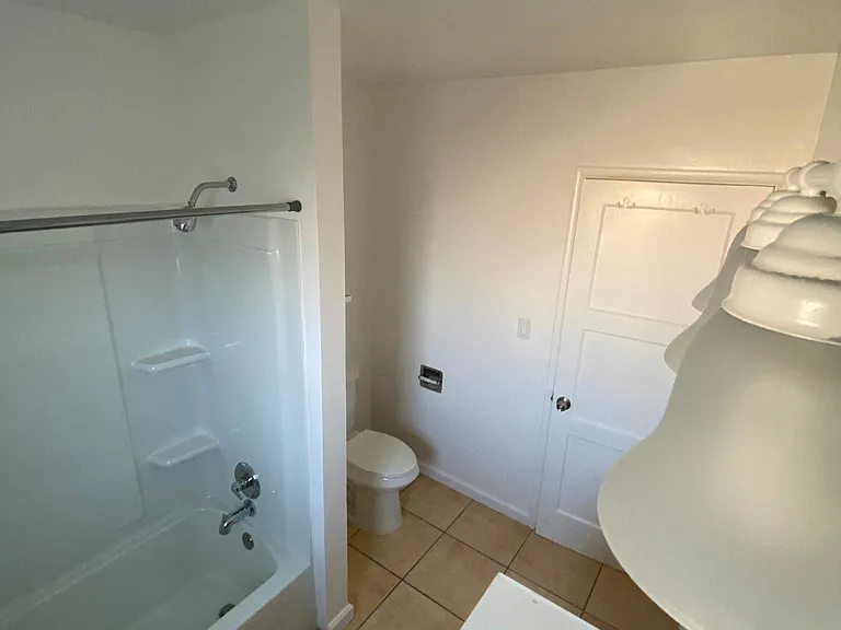 View of lighting in bathroom at Edison Apartments in Burbank, California.