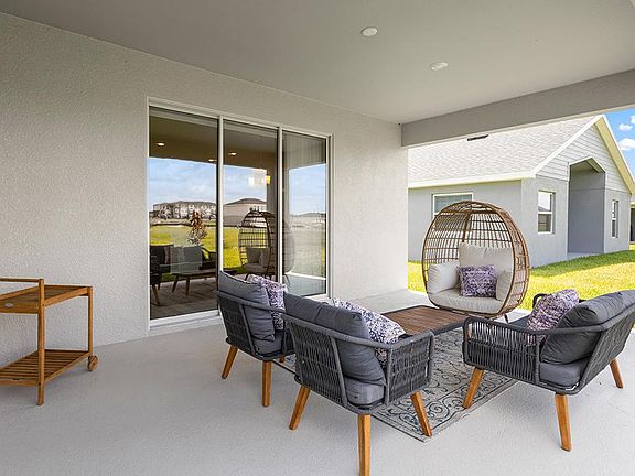 A triple slider opens the interior to desirable outdoor living space - Aubrey by Highland Homes