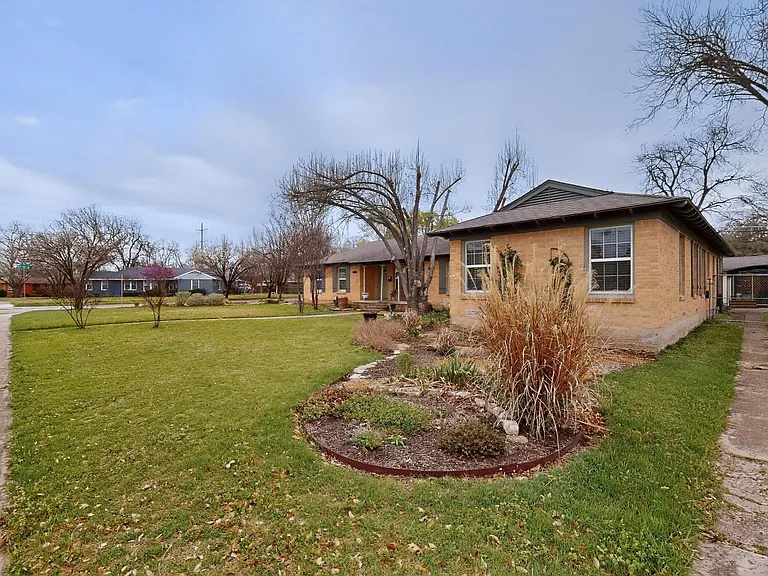 Pathway to Unit 1707 featuring a spacious yard surrounded by trees