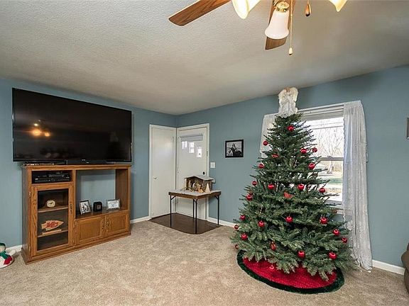 Front door, coat closet and living room