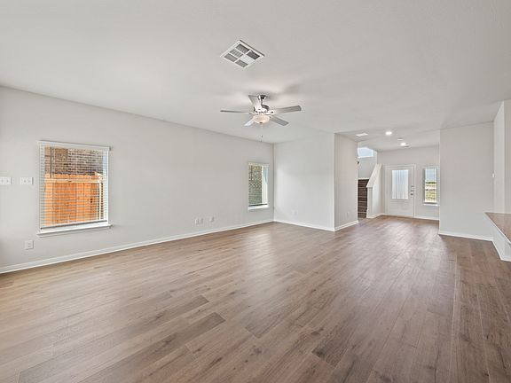 The kitchen, dining room, and living room all sit adjacent to one another.