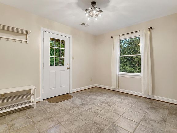 Main floor foyer. To immediate right is utility room with new washer, dryer, and utility sink