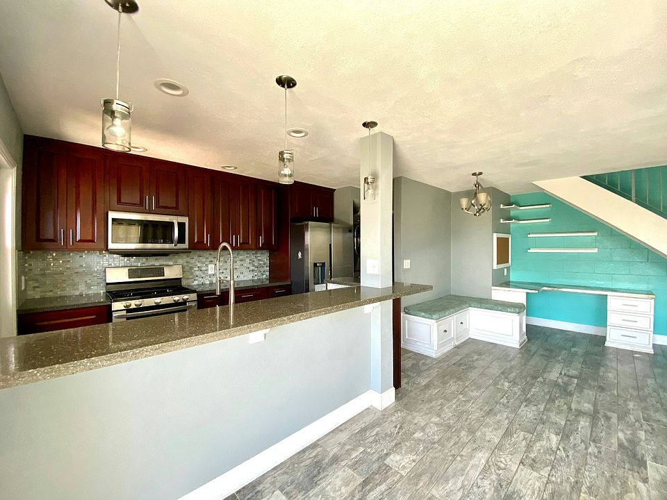 Built in office desk under stairs with floating shelves