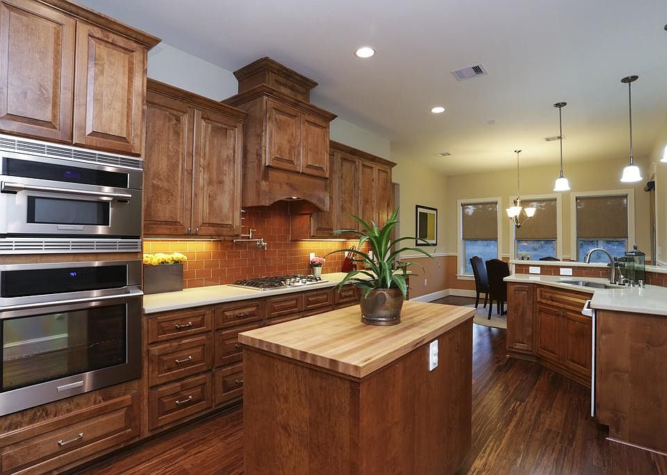 Chef's Dream Kitchen has everything you desire: top-of-the-line appliances & finishes, plenty of counter space & ample custom cabinetry for storage. The rich wood cabinets perfectly complement the bamboo flooring found throughout much of the home.