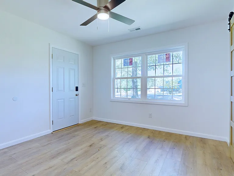 Bedroom 1. This bedroom has separate exterior door, ceiling fan, and a large reach-in closet.