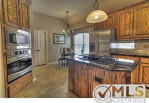 With a Kitchen equipped with gas cook top, stainless steel appli