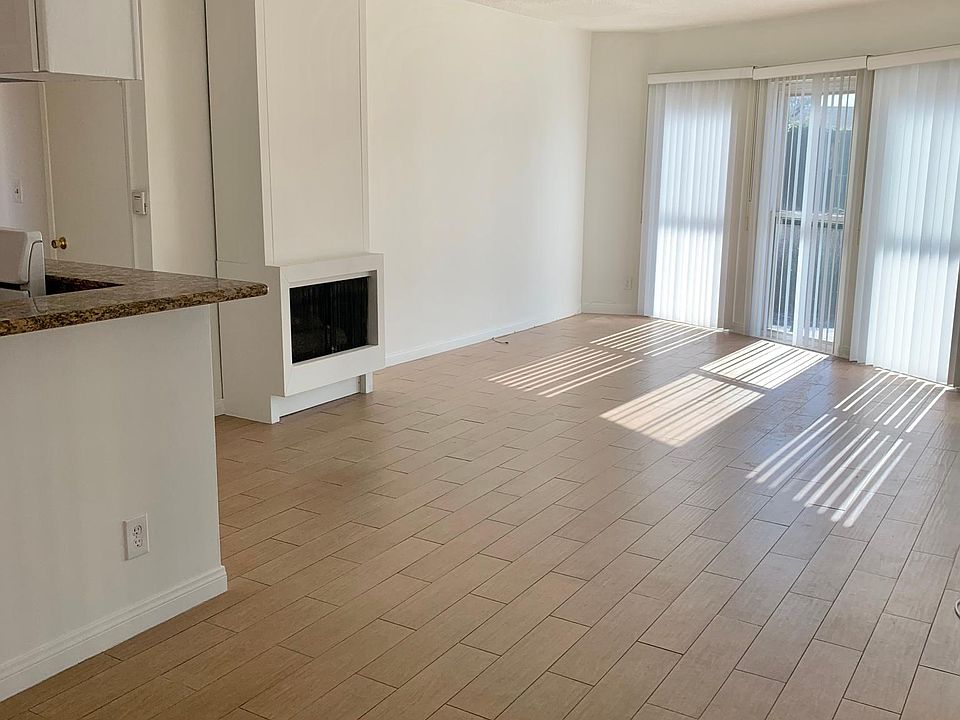 Spacious living room. Rounded windows and a working fireplace.