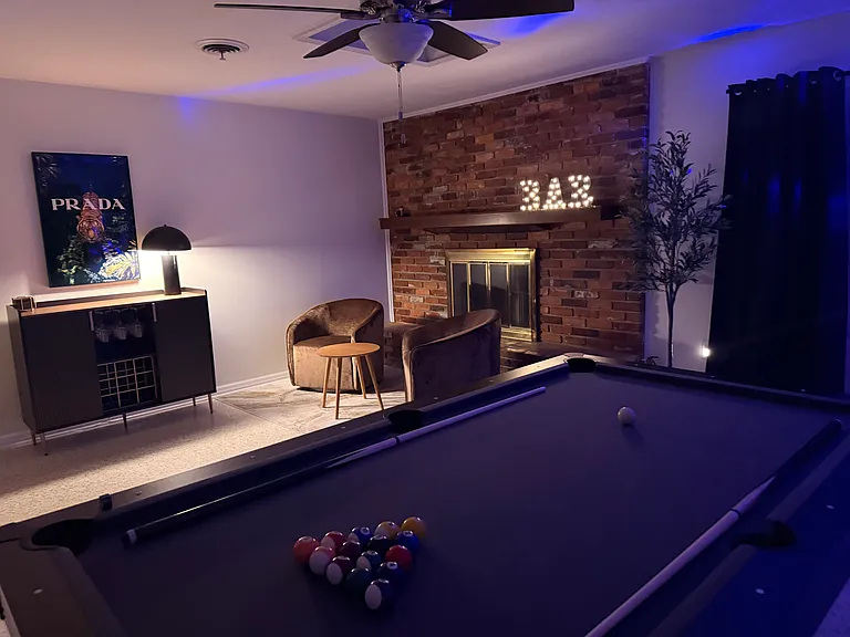Recreation room with wine bar, bar stools, sitting area, pool table and karaoke.