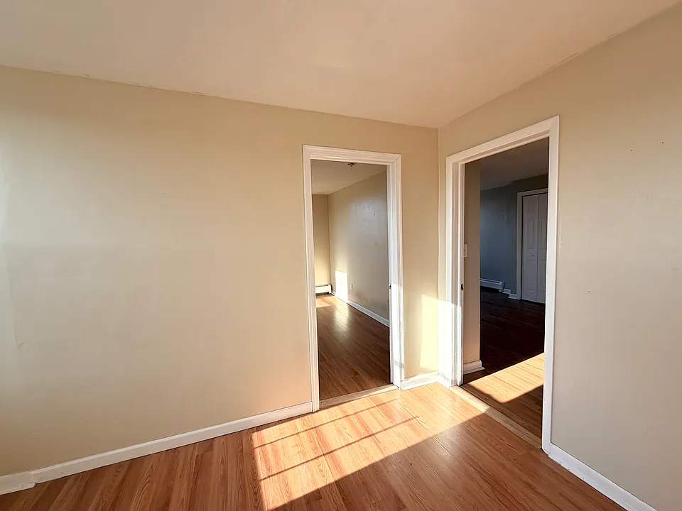 Living room, doors to two bedrooms
