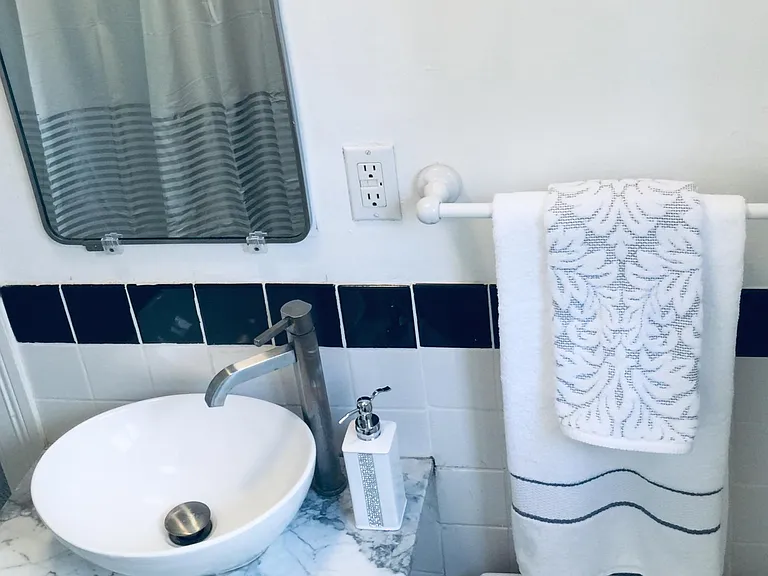 Vessel sink on white granite counter