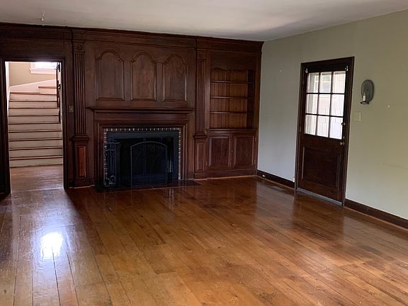 living room with wood burning fireplace.