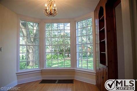 Great west facing view of the large backyard thru the bay windows