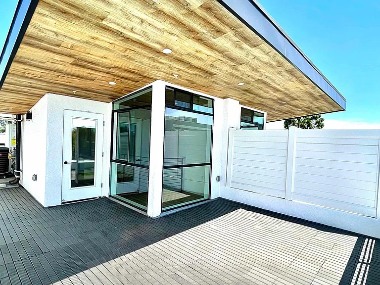 Private rooftop patio with decking and pet friendly synthetic turf. Shaded cantilever with dimmable led lighting. Sunset views.