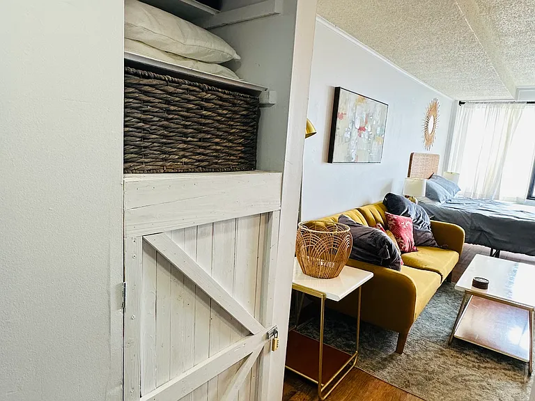 Hallway with additional storage closet and shelves