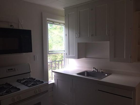 Kitchen stove, microwave, and kitchen sink.