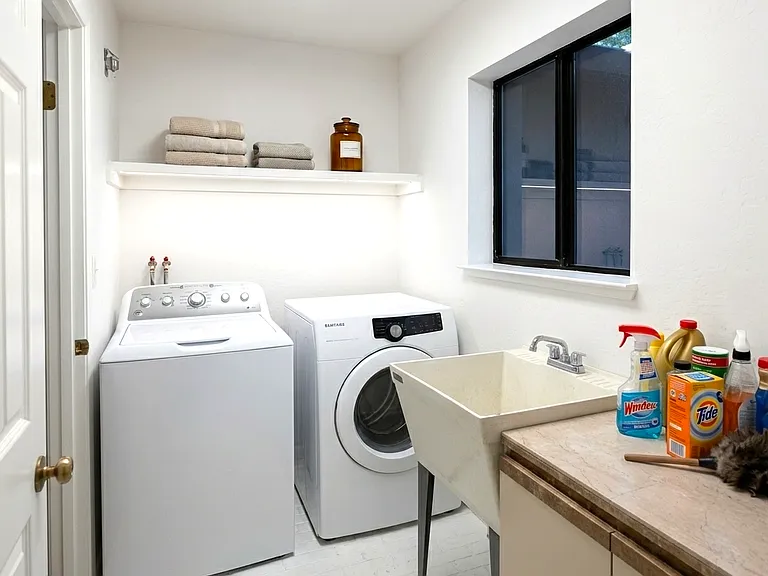 Laundry room: washer/dryer & utility sink.