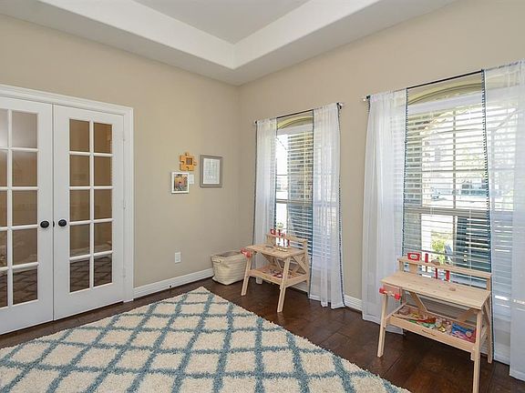 French doors lead into this study with hardwoods and tray ceiling.