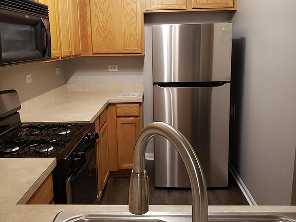 Kitchen with new faucet, new LG fridge, new amana stove/range. New flooring and paint.