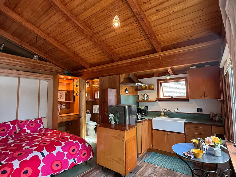 Murphy bed in studio, bathroom in southeast corner, kitchen