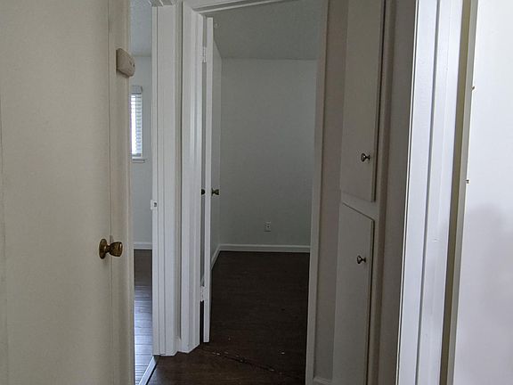 Hallway between bathroom (right) and bedrooms (front and left)