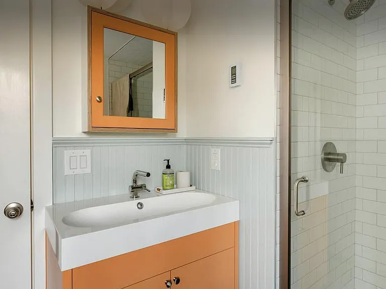 Upstairs bathroom with custom cabinetry.