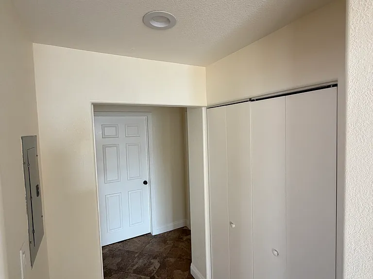 Laundry space doors and hallway into the last 2 bedrooms and bathroom.